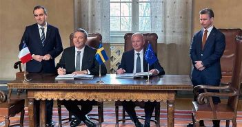 French-Swedish officials at signing ceremony.