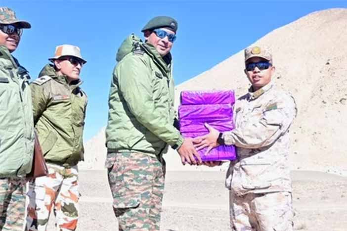 Indian Army, PLA troops exchange sweets on the occasion of Deepawali. 
